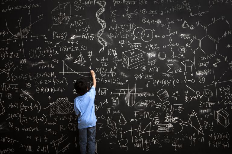 young boy writes math equations on chalkboard 168351254 5ad90020ba61770036501446